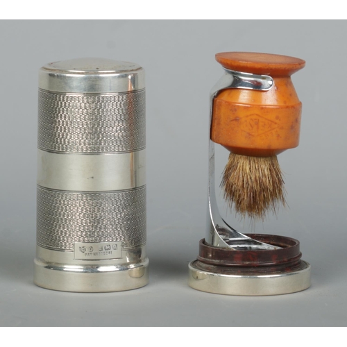 120 - A George V silver cylindrical shaving brush case with engine turned decoration. Housing a Kelson sha... 