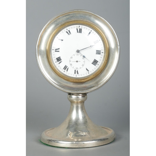 123 - A George V silver desk clock of circular form on pedestal base. Assayed Birmingham 1922 with partial... 