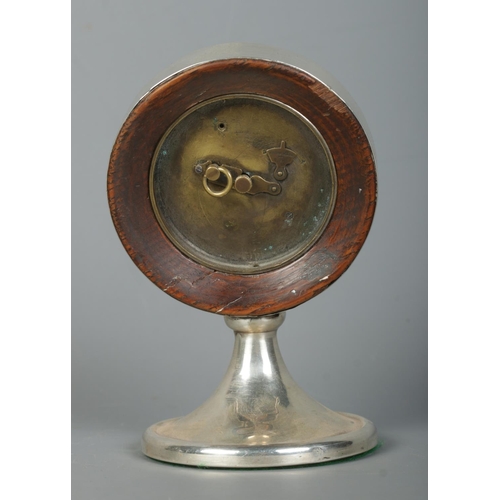 123 - A George V silver desk clock of circular form on pedestal base. Assayed Birmingham 1922 with partial... 