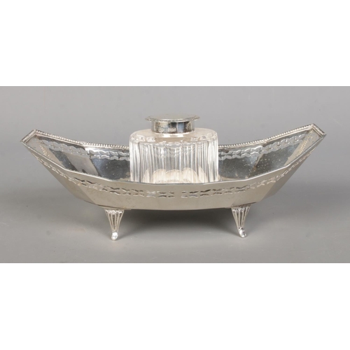 131 - An Edwardian silver and cut glass ink well in silver boat shaped stand. Assayed Chester 1908 by Geor... 