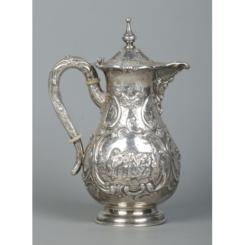 132 - An early 20th century hot water pot. Having repousse scrolling decoration and scenes depicting child... 