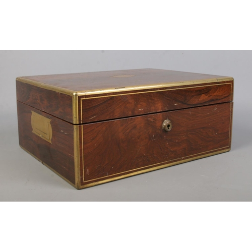 134 - A William IV brass bound rosewood vanity box with fitted silver and glass jars. The box and jars all... 