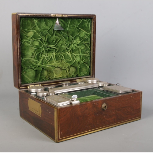 134 - A William IV brass bound rosewood vanity box with fitted silver and glass jars. The box and jars all... 