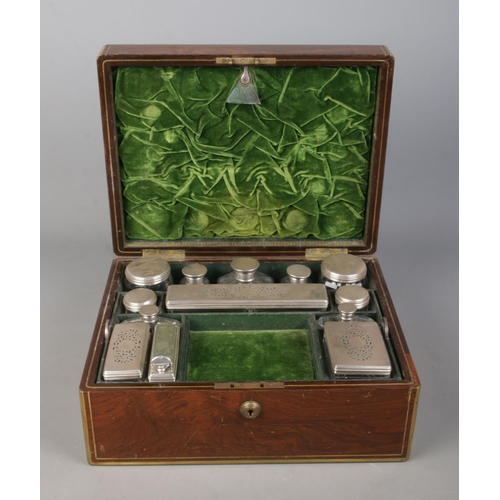 134 - A William IV brass bound rosewood vanity box with fitted silver and glass jars. The box and jars all... 