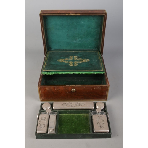 134 - A William IV brass bound rosewood vanity box with fitted silver and glass jars. The box and jars all... 