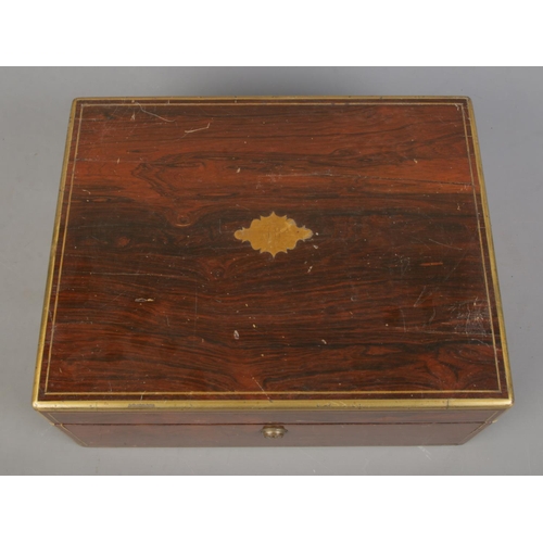 134 - A William IV brass bound rosewood vanity box with fitted silver and glass jars. The box and jars all... 