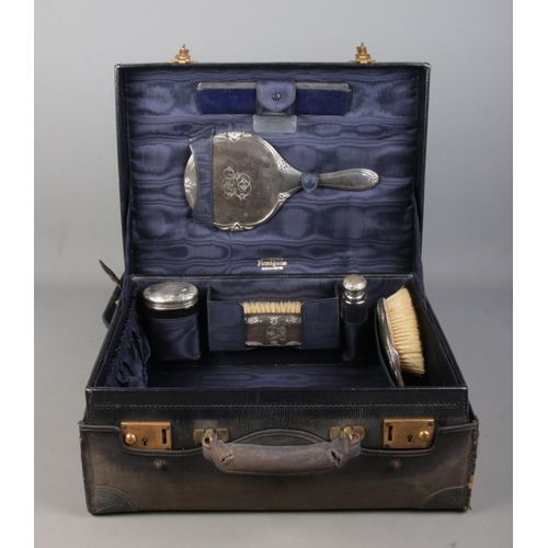 135 - A Finnigans of Manchester vanity case with assembled silver mounted accoutrements all bearing the sa... 