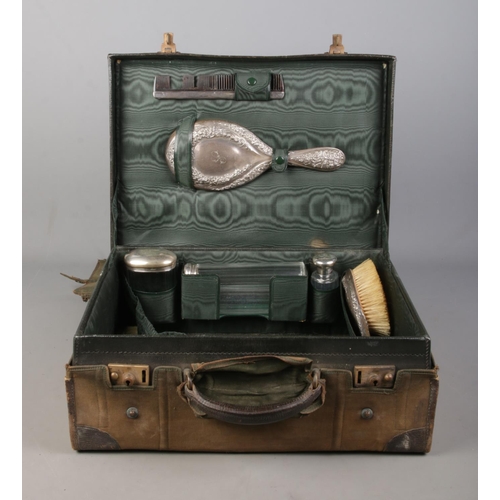 136 - A Finnigans of Manchester leather vanity case with contents of assembled silver mounted accoutrement... 