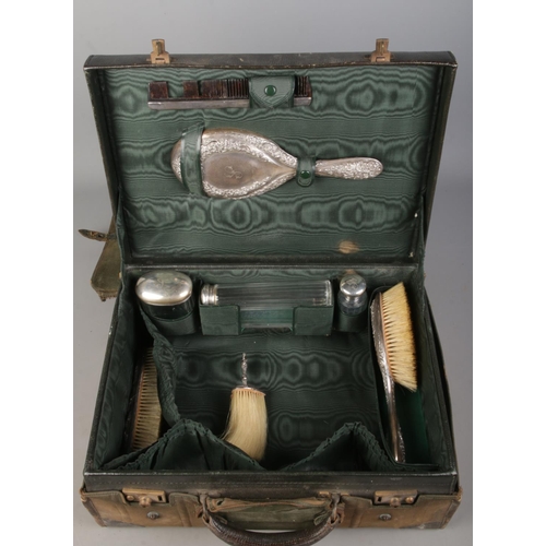 136 - A Finnigans of Manchester leather vanity case with contents of assembled silver mounted accoutrement... 