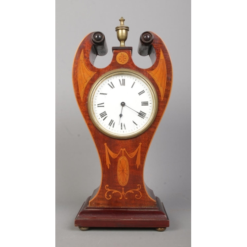 141 - An Edwardian inlaid mahogany twin swan neck mantel clock. Having Roman numeral markers and French mo... 