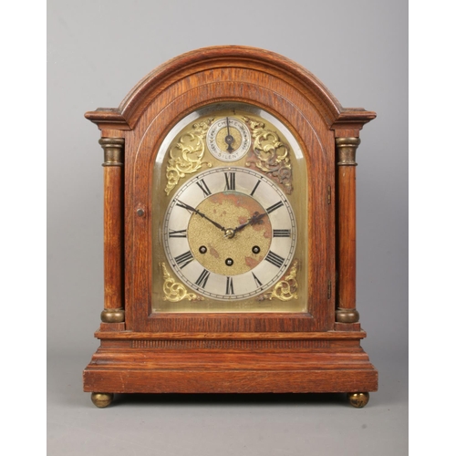 143 - An oak cased Gustav Becker bracket clock. With brass dial, Roman numeral markers and subsidiary dial... 