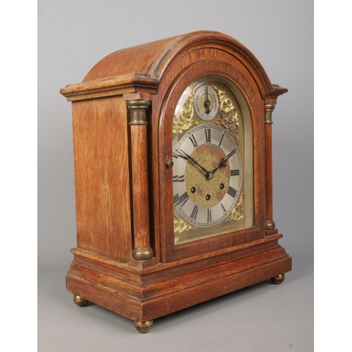 143 - An oak cased Gustav Becker bracket clock. With brass dial, Roman numeral markers and subsidiary dial... 