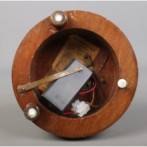 145 - An early 20th century Bulle electro magnetic clock under glass dome, raised on wooden stand. 26.5cm.