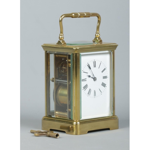 146 - An early 20th century brass and glass repeater carriage clock. Having swing handle, Roman numeral ma... 