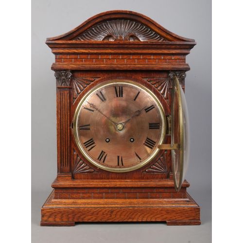 147 - A carved oak cased Winterhalder & Hofmeier bracket clock. Having Roman numeral markers and chiming o... 