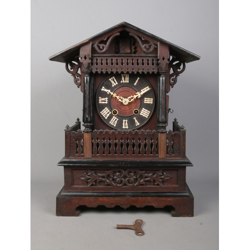 148 - A late 19th/early 20th century Black Forest cuckoo mantel clock. Housing twin train movement and chi... 