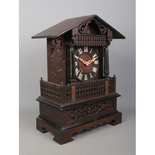 148 - A late 19th/early 20th century Black Forest cuckoo mantel clock. Housing twin train movement and chi... 