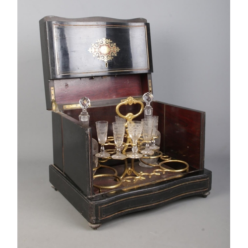 152 - A French 19th century ebonised liquor cabinet with brass and walnut inlaid decoration. Contents of s... 