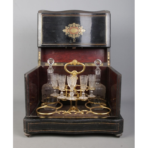 152 - A French 19th century ebonised liquor cabinet with brass and walnut inlaid decoration. Contents of s... 