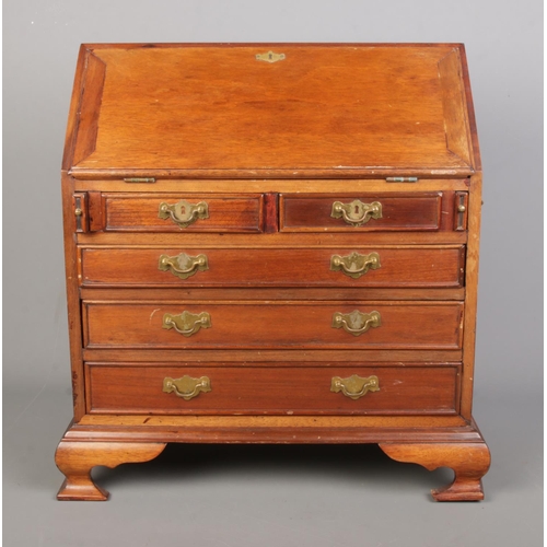 153 - A miniature mahogany bureau in the Georgian style with brass fittings. Height 46.5cm, Width 45cm, De... 