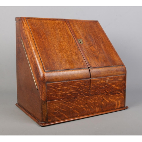 156 - An early 20th century oak desk tidy with fitted interior and perpetual calendar. Height 33cm, Width ... 