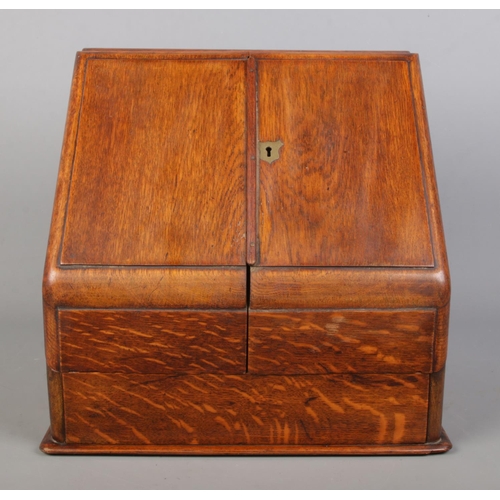 156 - An early 20th century oak desk tidy with fitted interior and perpetual calendar. Height 33cm, Width ... 