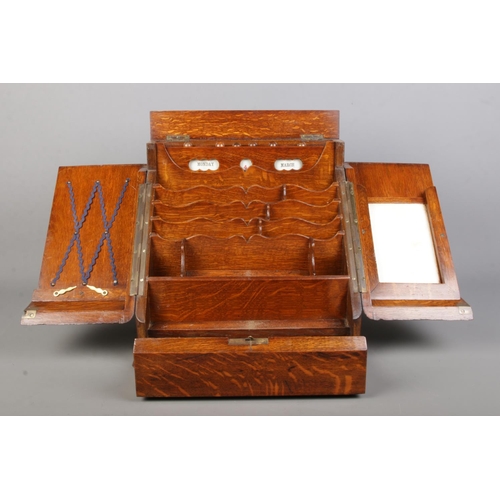 156 - An early 20th century oak desk tidy with fitted interior and perpetual calendar. Height 33cm, Width ... 