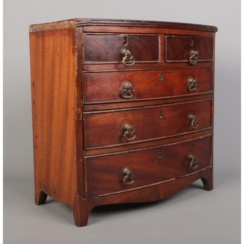 157 - A miniature mahogany bow front chest in the Victorian style. Height 31cm, Width 31cm, Depth 16cm.