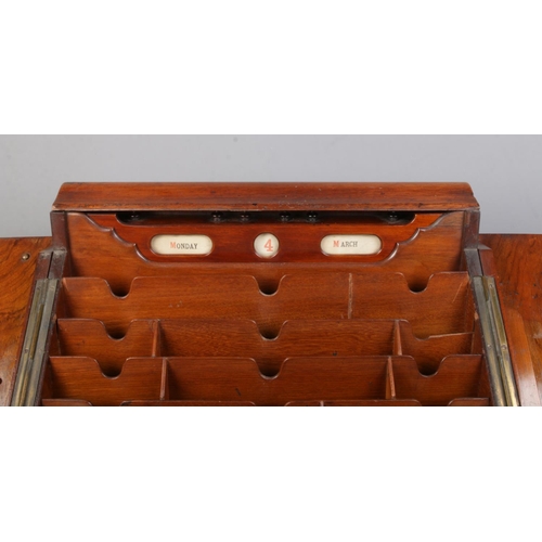 159 - A Victorian walnut and mahogany desk tidy with fitted interior and perpetual calendar. Height 33cm, ... 