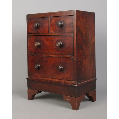 160 - A Georgian style mahogany miniature chest of two over two drawers. Height 37cm.