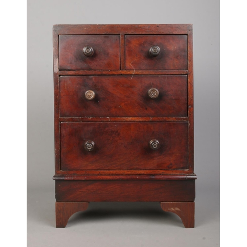 160 - A Georgian style mahogany miniature chest of two over two drawers. Height 37cm.