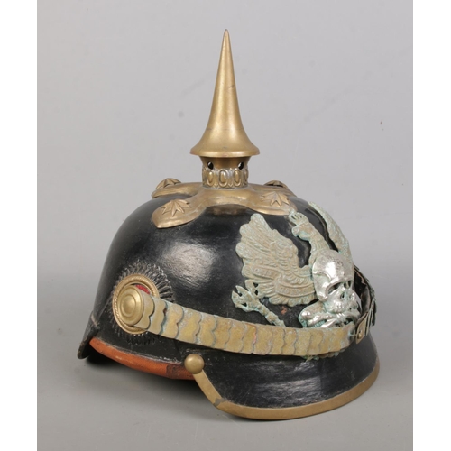 174 - A World War One Imperial German officers pickelhaube. Bearing eagle badge with motto Mit Gott Fur Ko... 