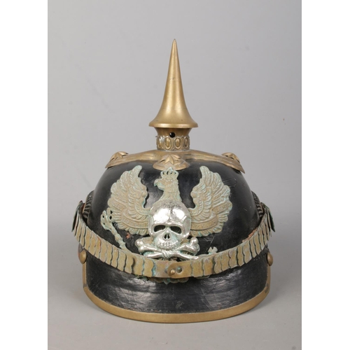 174 - A World War One Imperial German officers pickelhaube. Bearing eagle badge with motto Mit Gott Fur Ko... 