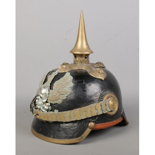 174 - A World War One Imperial German officers pickelhaube. Bearing eagle badge with motto Mit Gott Fur Ko... 