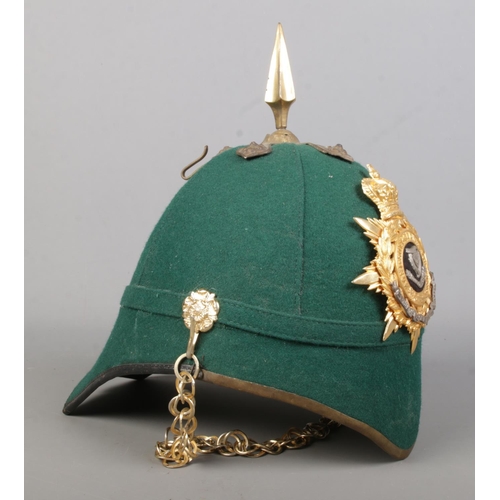 177 - A dark green cloth spiked helmet bearing Connaught Rangers badge.