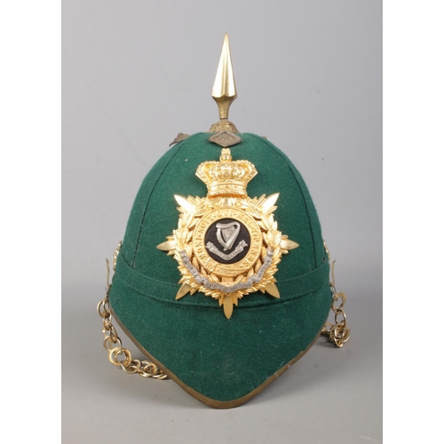 177 - A dark green cloth spiked helmet bearing Connaught Rangers badge.