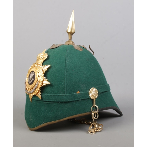 177 - A dark green cloth spiked helmet bearing Connaught Rangers badge.