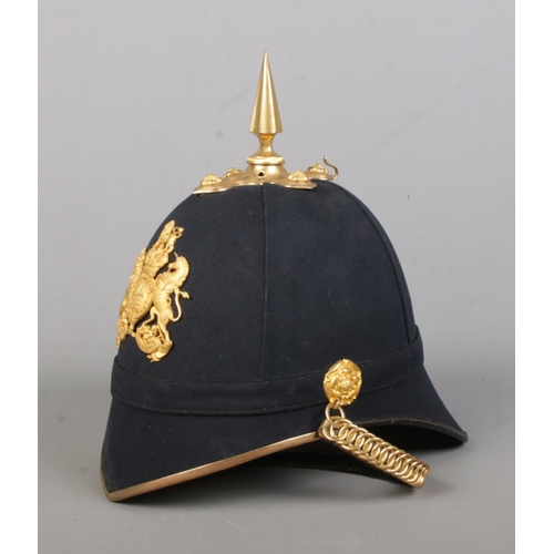 178 - A British Royal Artillery helmet with blue cloth and spike. Inside of helmet marked for Guthrie & Va... 