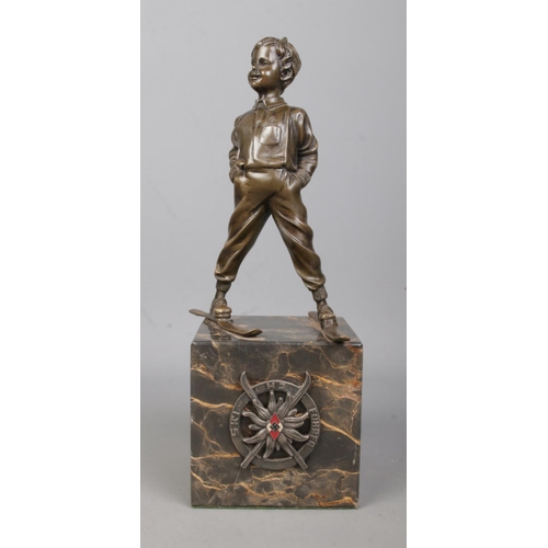 180 - After Johann Ferdinand Preiss, a bronze sculpture of a young boy wearing skis. Having HJ Ski Fuhrer ... 