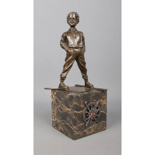 180 - After Johann Ferdinand Preiss, a bronze sculpture of a young boy wearing skis. Having HJ Ski Fuhrer ... 