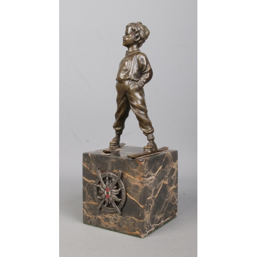 180 - After Johann Ferdinand Preiss, a bronze sculpture of a young boy wearing skis. Having HJ Ski Fuhrer ... 