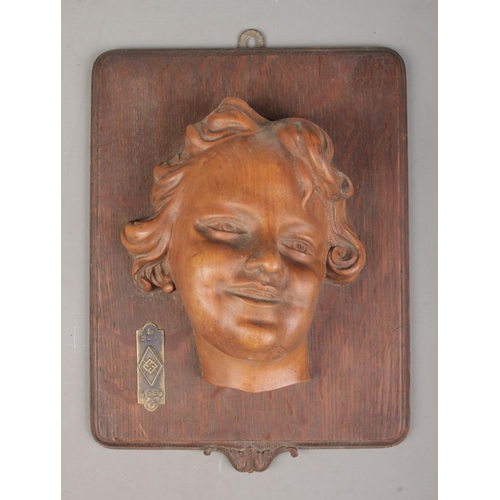 185 - A carved wooden wall plaque of a young girl. The plaque bearing German BDM (League of German Girls) ... 