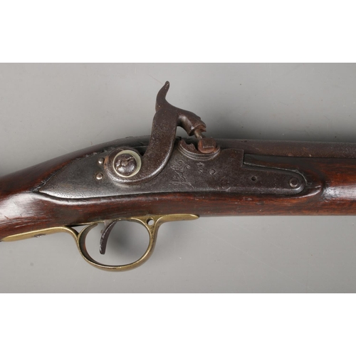 195 - A 19th century rifle with walnut stock. Percussion conversion from flint lock. The lock plate bearin... 