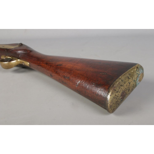 195 - A 19th century rifle with walnut stock. Percussion conversion from flint lock. The lock plate bearin... 