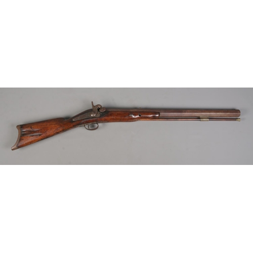 196 - An 19th century heavy percussion rifle with octagonal barrel. Barrel length 72cm. CANNOT POST.