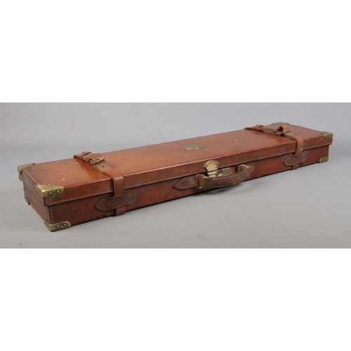 202 - A 19th century leather gun case with fitted interior. Having brass mounts, monogrammed WWK. Length 8... 