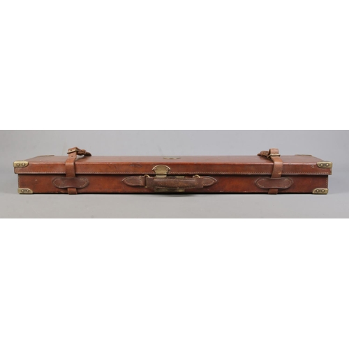 202 - A 19th century leather gun case with fitted interior. Having brass mounts, monogrammed WWK. Length 8... 