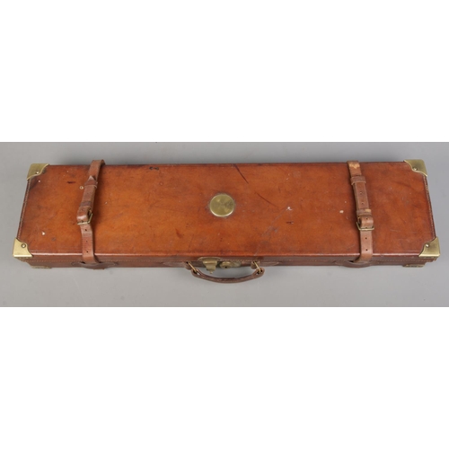 202 - A 19th century leather gun case with fitted interior. Having brass mounts, monogrammed WWK. Length 8... 