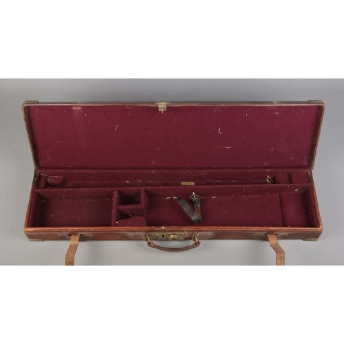 202 - A 19th century leather gun case with fitted interior. Having brass mounts, monogrammed WWK. Length 8... 