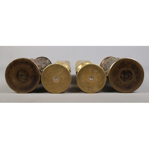 207 - Two pairs of World War One trench art artillery shells. One pair extensively decorated with flowers.... 